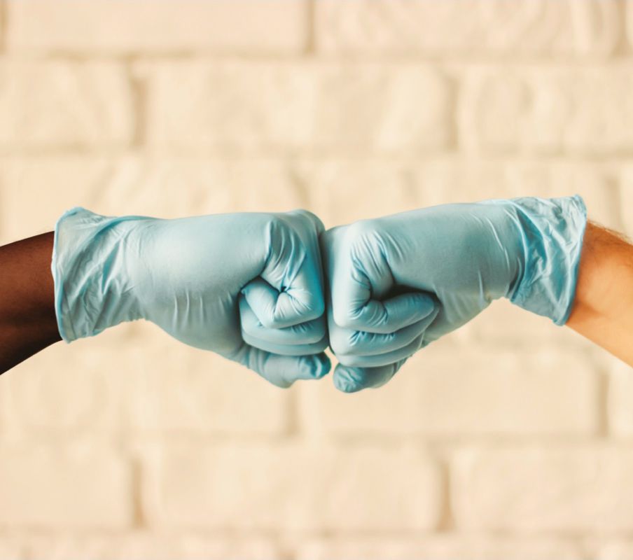 Two hard working Northeast Foods employees fist bumping.